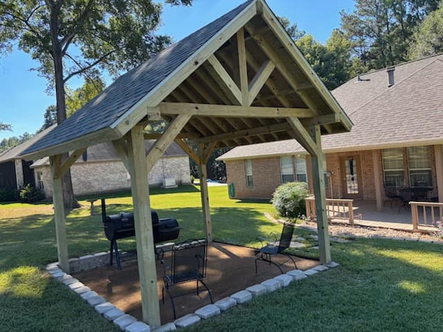 Freestanding wood BBQ pavilion with shingle roof built by Rockin' D Services in Huntsville, TX