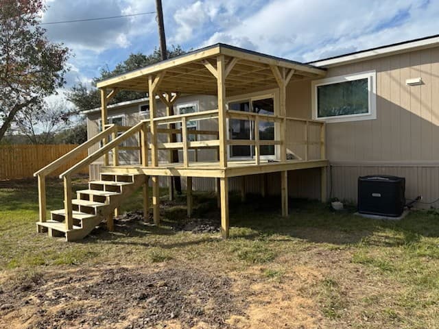 Covered wood deck and porch built onto a home by Rockin' D Services in Huntsville, TX
