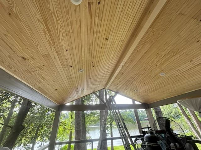 Tongue-and-groove wood ceiling on a screened porch overlooking the lake, built by Rockin' D Services