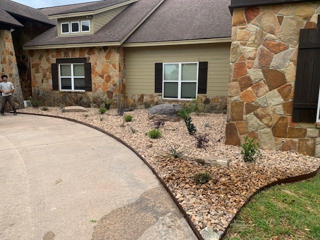 Rock landscaping and planting bed installation by Rockin' D Services in Huntsville TX