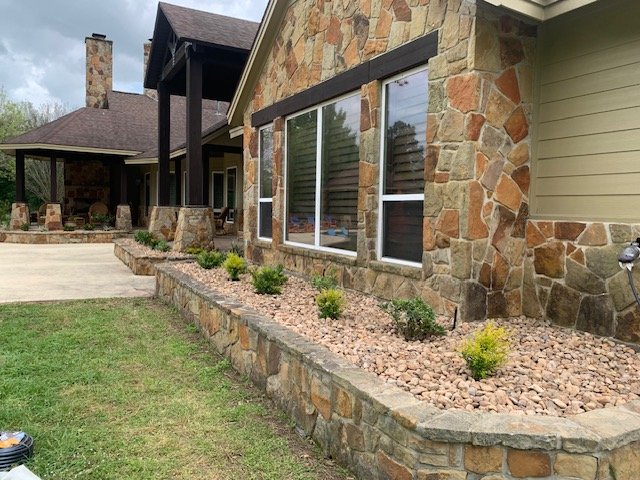Custom concrete wall with flagstone stone veneer installed by Rockin' D Services in Huntsville TX