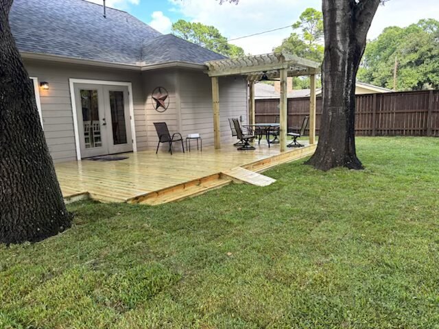 Custom deck and outdoor living space with pergola built by Rockin' D Services in Huntsville TX