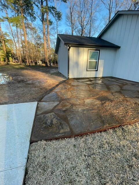 Natural flagstone patio and outdoor living area installed by Rockin' D Services in Huntsville TX