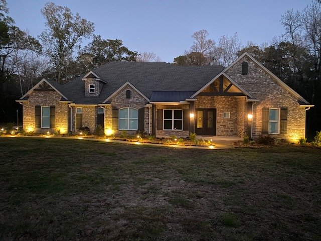 Professional front yard landscape lighting installed by Rockin' D Services in Huntsville TX