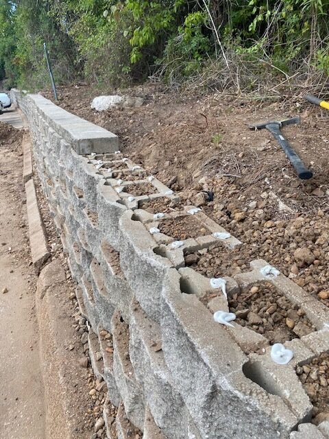 Block retaining wall construction with drainage and backfill preparation in Huntsville TX