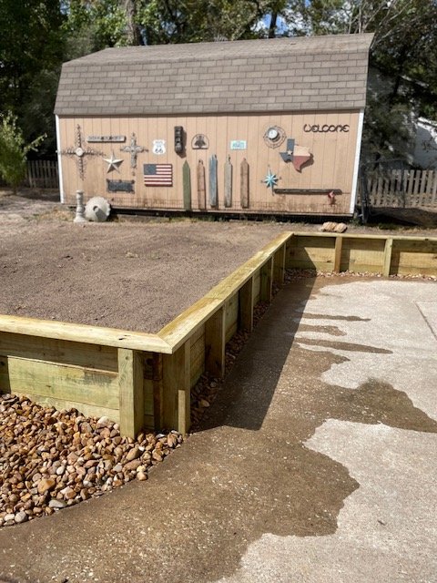 Timber retaining wall installation for landscape grade control by Rockin' D Services in Huntsville TX